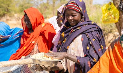 Woman smiles and receives emergency food.