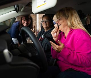 Sherri Hughes celebrates the Toyota Corolla she received from Samaritan's Purse. She praises God for His provision for her after Hurricane Helene took everything.