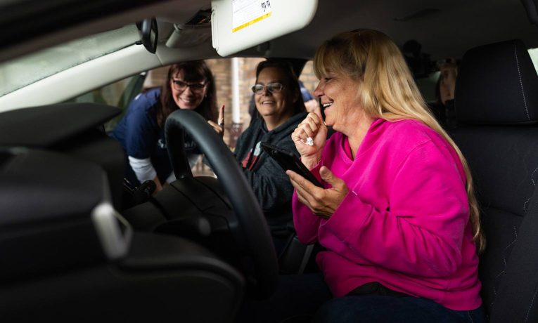 Sherri Hughes celebrates the Toyota Corolla she received from Samaritan's Purse. She praises God for His provision for her after Hurricane Helene took everything.