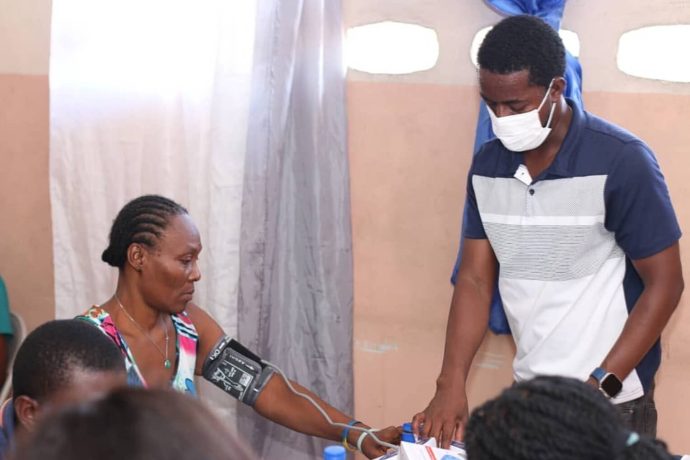 a woman's blood pressure is taken at a clinic in Haiti
