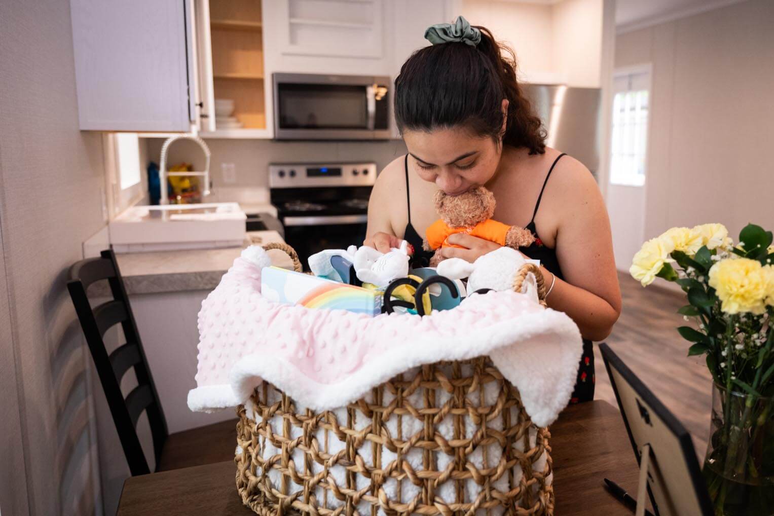 Karina takes a moment to enjoy the housewarming gifts from Samaritan Purse.