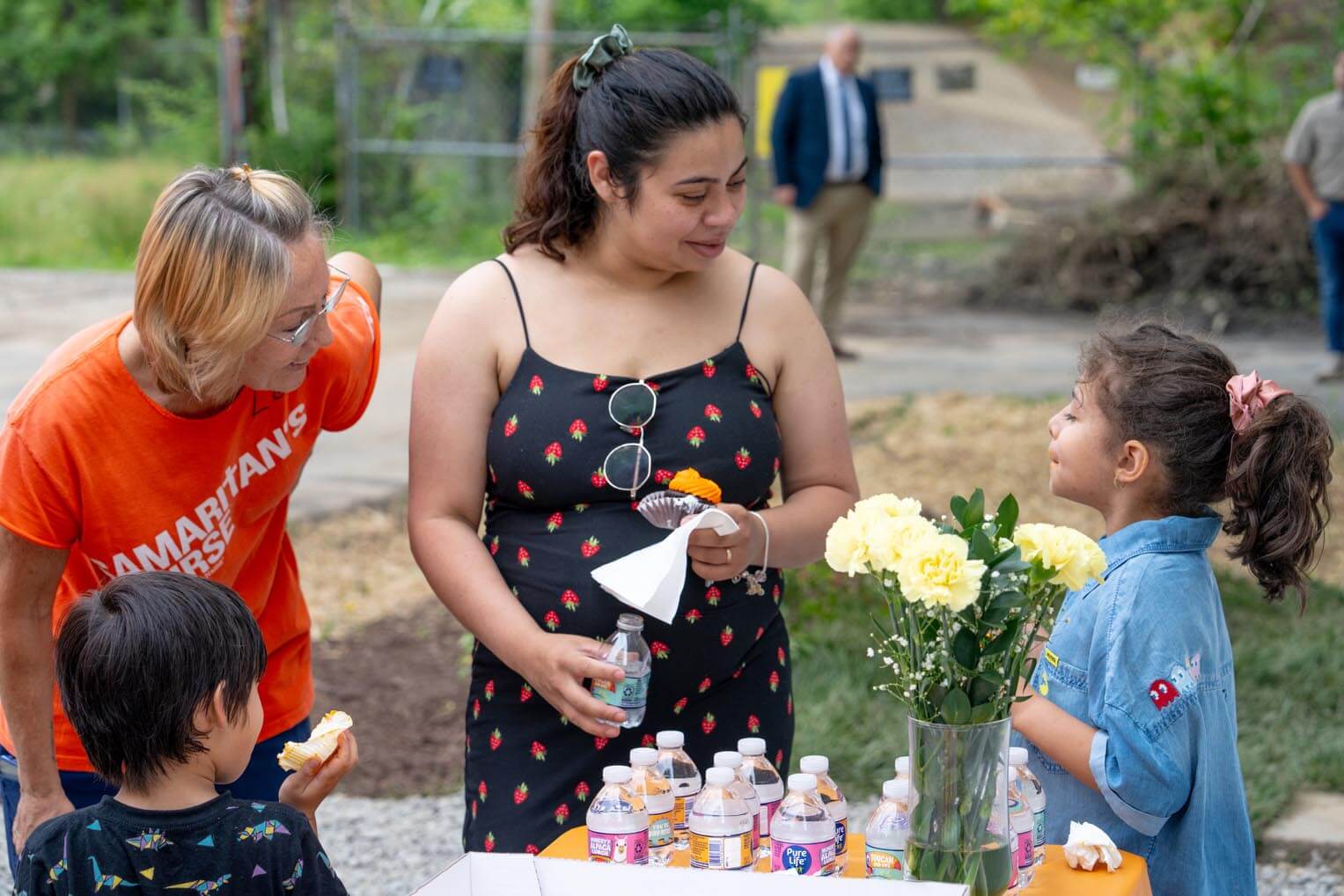 Karina Ramos celebrates her new home with her children and a Samaritan's Purse volunteer.