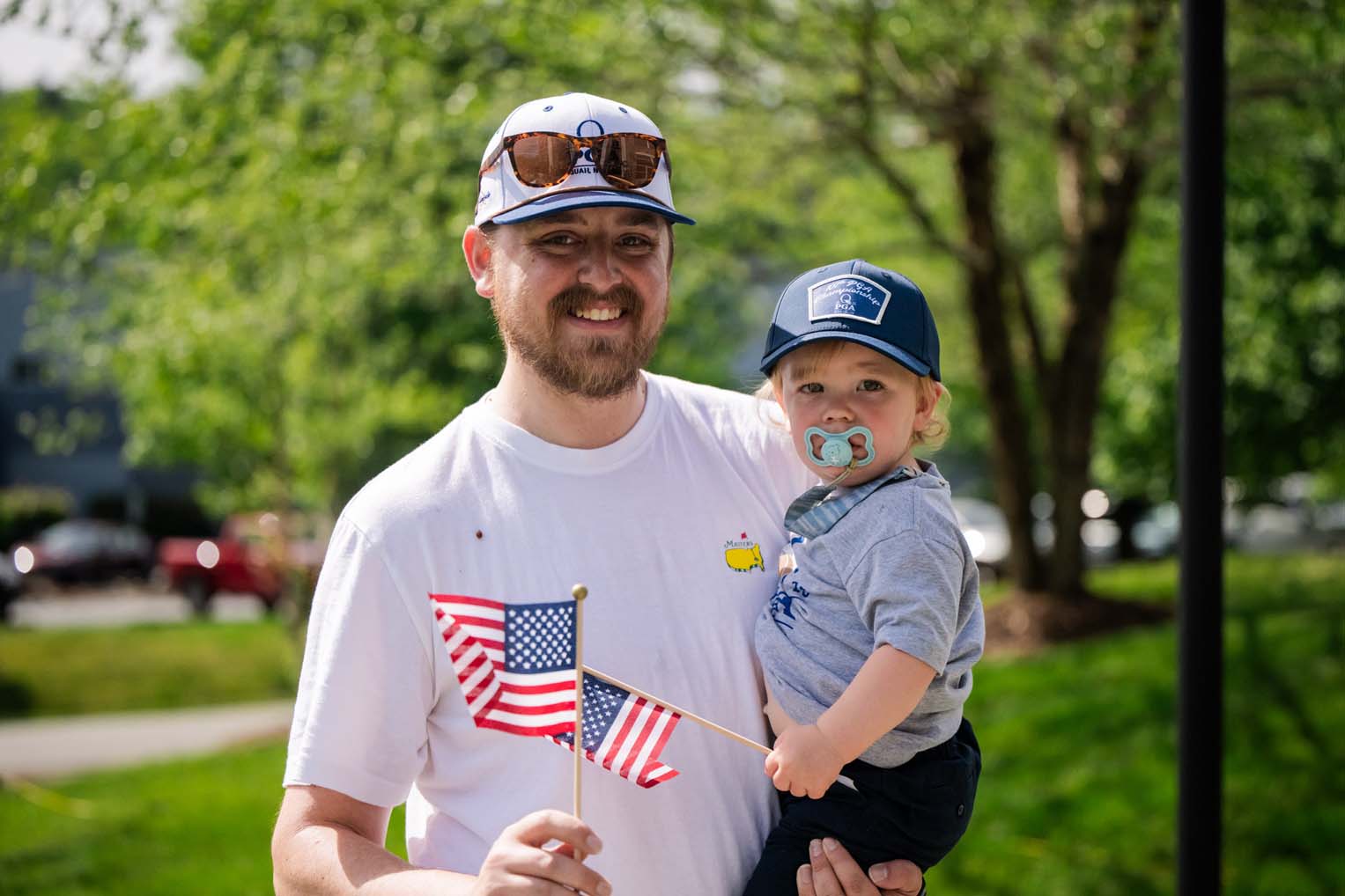A father and son join the crowd to cheer on riders during the 14th annual High Country Warrior Ride.