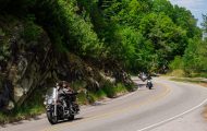 Riders wave as they curve through the Blue Ridge Mountains during the High Country Warrior Ride.