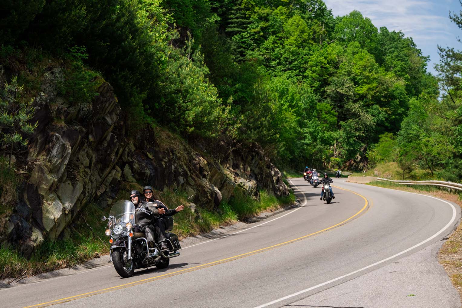 Riders wave as they curve through the Blue Ridge Mountains during the High Country Warrior Ride.