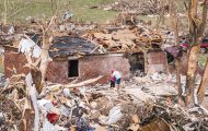 People hug amid the devastation brought by an EF3 tornado in London, Kentucky.
