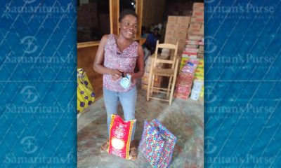 Haitian woman receives bags of food