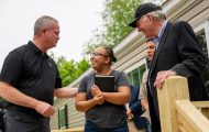 North American Ministries staffer Brent Graybeal encourages Lidia Gomez alongside Franklin Graham.