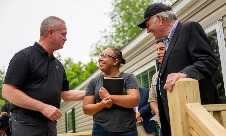 North American Ministries staffer Brent Graybeal encourages Lidia Gomez alongside Franklin Graham.
