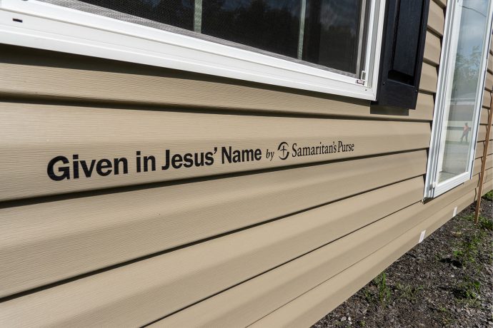 message on side of house that home was given in Jesus' Name