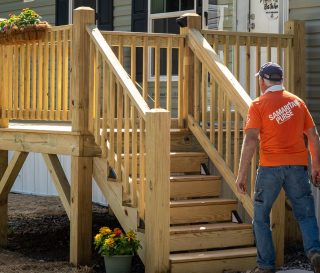 Samaritan's Purse volunteer in front of mobile home