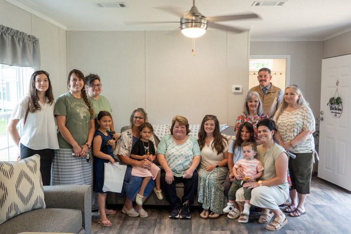homeowner with church members in new living room