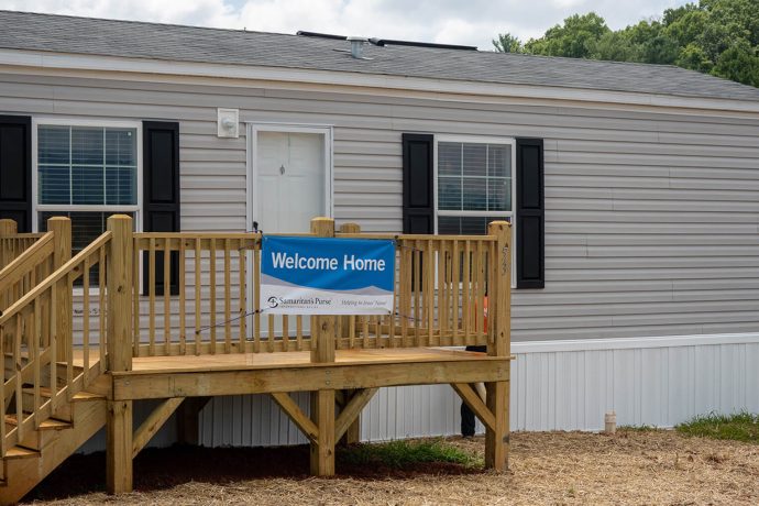 a welcome home sign on front porch of new mobile home