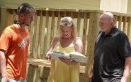 Samaritan's Purse staff member presents new homeowners with photo album of the rebuild.