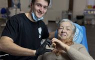 Dentist and patient make heart sign with hands