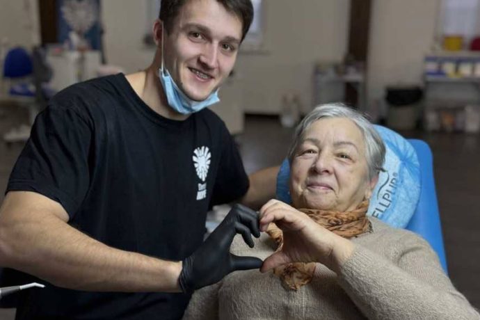 Dentist and patient make heart sign with hands