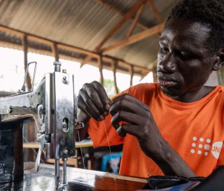 Timothy is eager to return to his village as a tailor. This new trade skill allows him to settle his family and represents a movement toward a foundation of peace in his country.