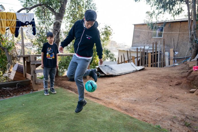 John kicks soccer ball received in shoebox gift
