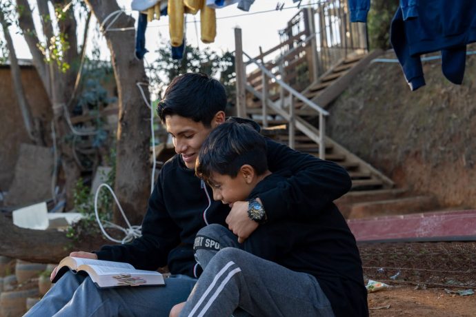 brothers embrace while studying God's Word