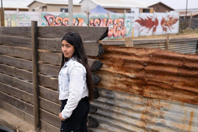 Fernanda in front of charred wood