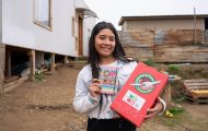Girl in Chile with shoebox gift and the notebook it contained
