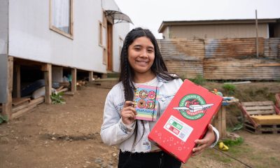 Girl in Chile with shoebox gift and the notebook it contained