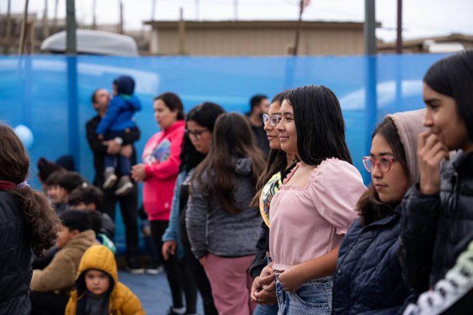 Girl watches outreach event in Chile