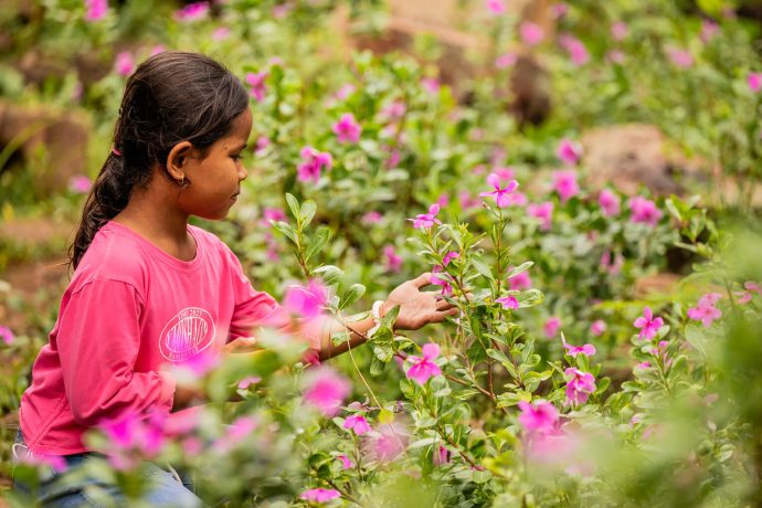 Tola admires flowers