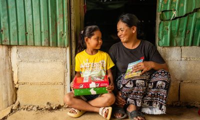 mother and daughter with shoebox gift and Gospel booklet