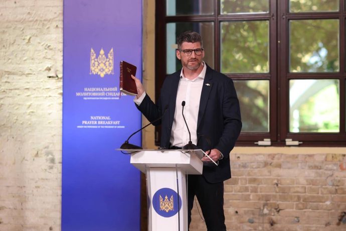 Edward Graham preaches with Bible in hand at the Ukraine Prayer Breakfast
