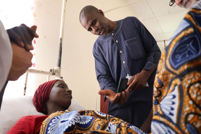 Pastor Babangida shares the Gospel with an ethnically Fulani woman, and gifts her with an audio Bible in her heart language, Fulfulde, provided by Samaritan's Purse.