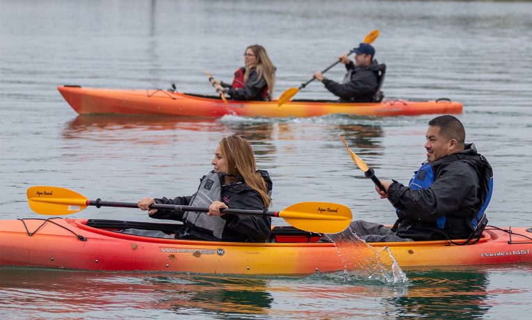 Military couples kayak in Lake Clark through Operation Heal Our Patriots.