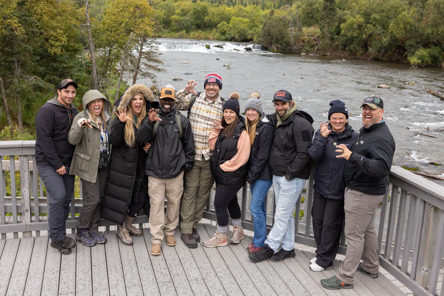 From left to right: Mike and Nikki Navarro, Ana and Kori Agyeman, Bryan and Aubre Duhon, Andrea and Nate Hruska, Kim and Jame Baum have a little fun at Brooks Falls in Katmai National Park, Alaska.