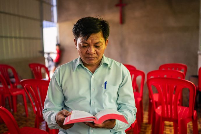 Pastor Ponleu reads the Bible