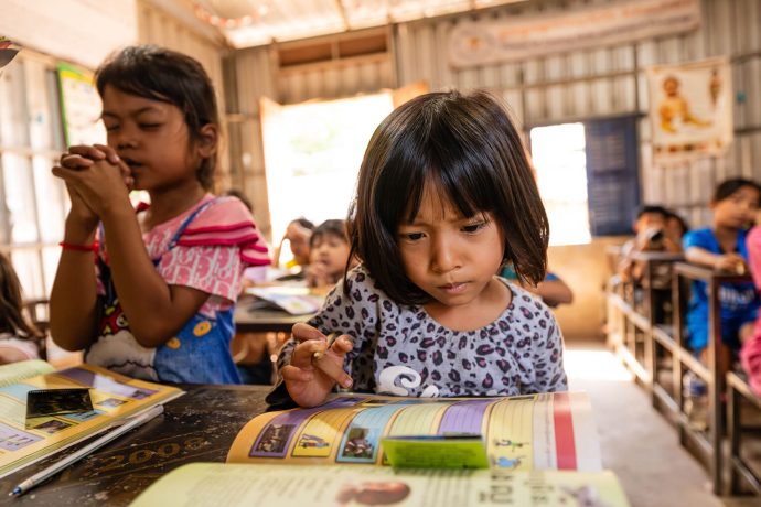 Cambodian girls pray and study The Greatest Journey lessons