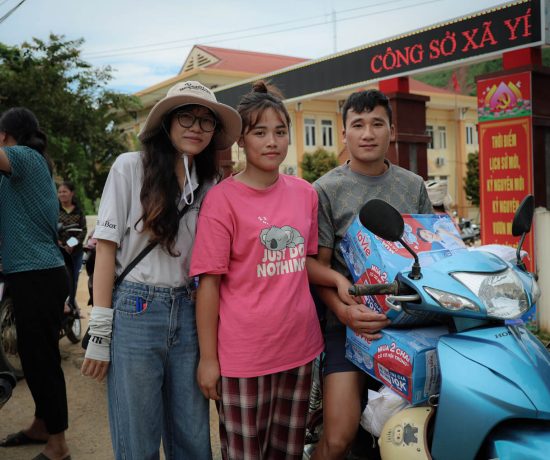 Mai (center) and her husband departed the Samaritan's Purse distribution site with a newfound sense of hope, and relief supplies piled on their motorcycle. 