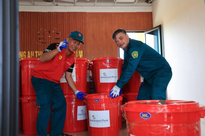 Staff unload buckets stuffed full with relief supplies to distribute to families in Vietnam reeling from Typhoon Kajiki.