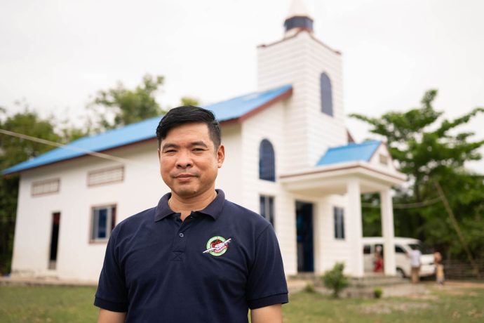 Nisay in front of a church