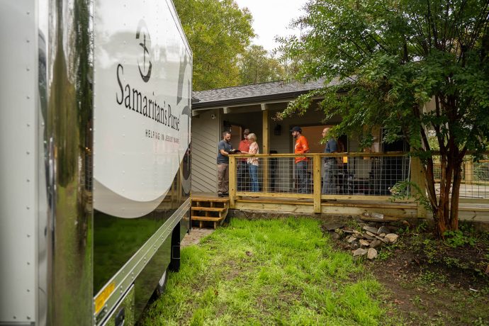 Samaritan's Purse team presents Gospel on porch with truck in the foreground