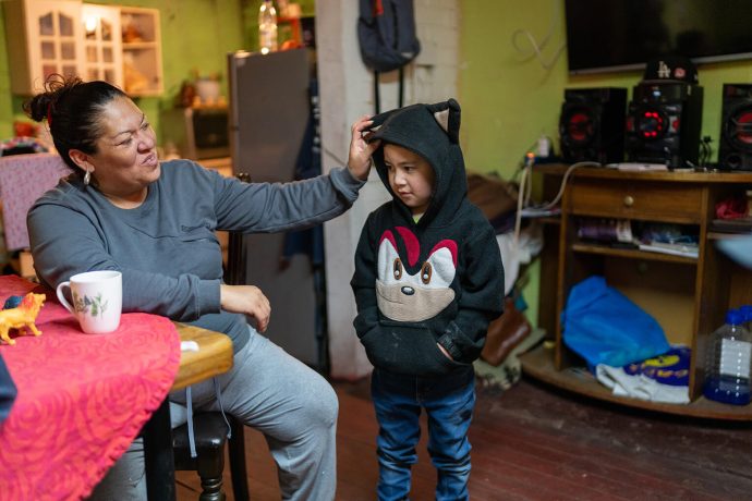 Mother adjusts sons sweatshirt