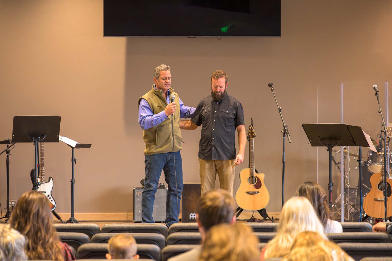 Project foreman Russ Richardson prays for Pastor Luke after handing him the keys to the new building.