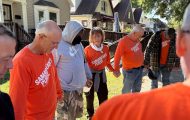 Volunteers pray with a homeowner impacted by the floods in Milwaukee, Wisconsin.