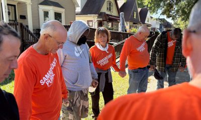Volunteers pray with a homeowner impacted by the floods in Milwaukee, Wisconsin.