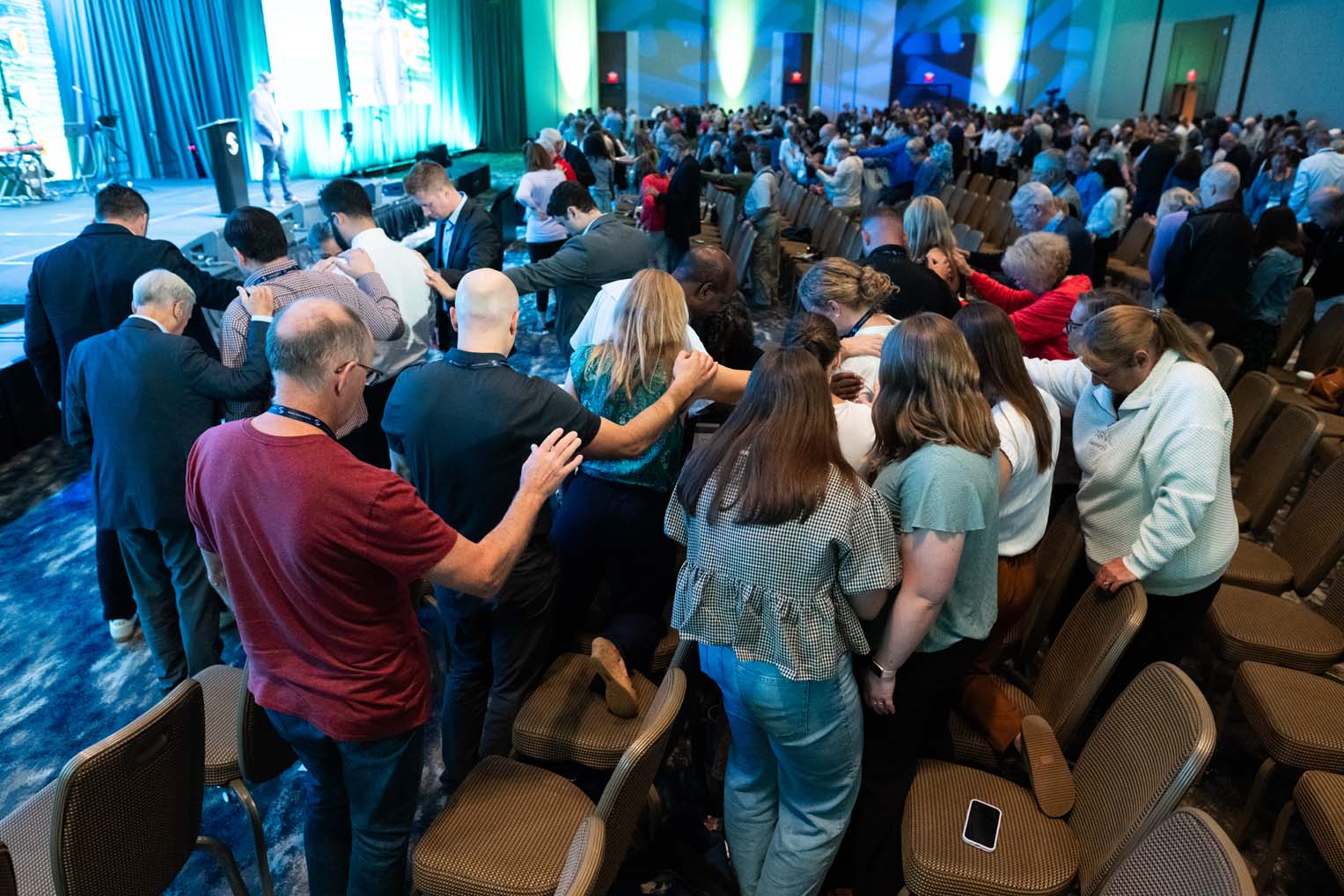 Attendees gathered for prayer during a general session.