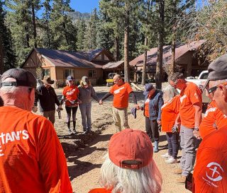 Volunteers pray with Colorado food victim