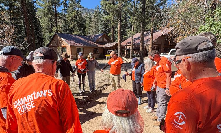 Volunteers pray with Colorado food victim