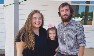 The Egger family poses for a photo in front of their new home built by Samaritan's Purse.