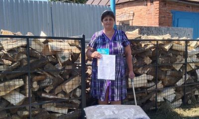 Ukrainian woman with firewood and Bible from Samaritan's Purse