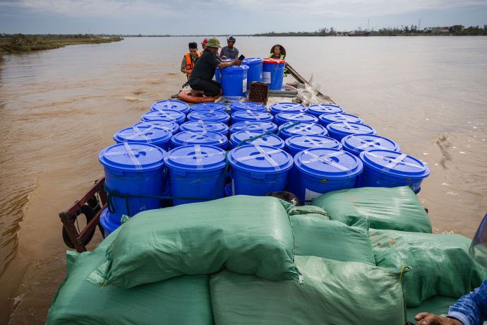 A boatful of Samaritan's Purse relief supply kits makes its way across the river to a remote island village in central Vietnam.