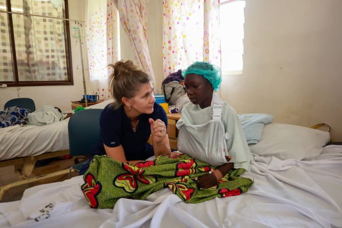 Schuster talks with Hellen as she works through rehabilitation for her elbow. "It's the honor of my life to serve these patients," she said about her experience working with Samaritan's Purse in Nigeria. 